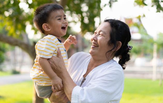 Grandmother is holding her grandson.