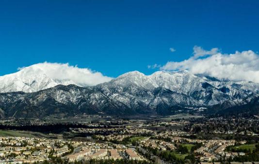 Panoramic view of the snow-covered Mount San Gorgonio and the Little San Bernardino Mountains.