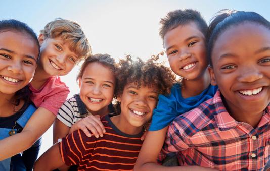 A group of kids looking at the camera. 