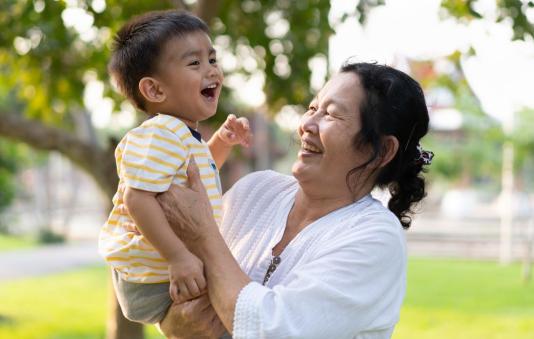 Grandmother is holding her grandson.
