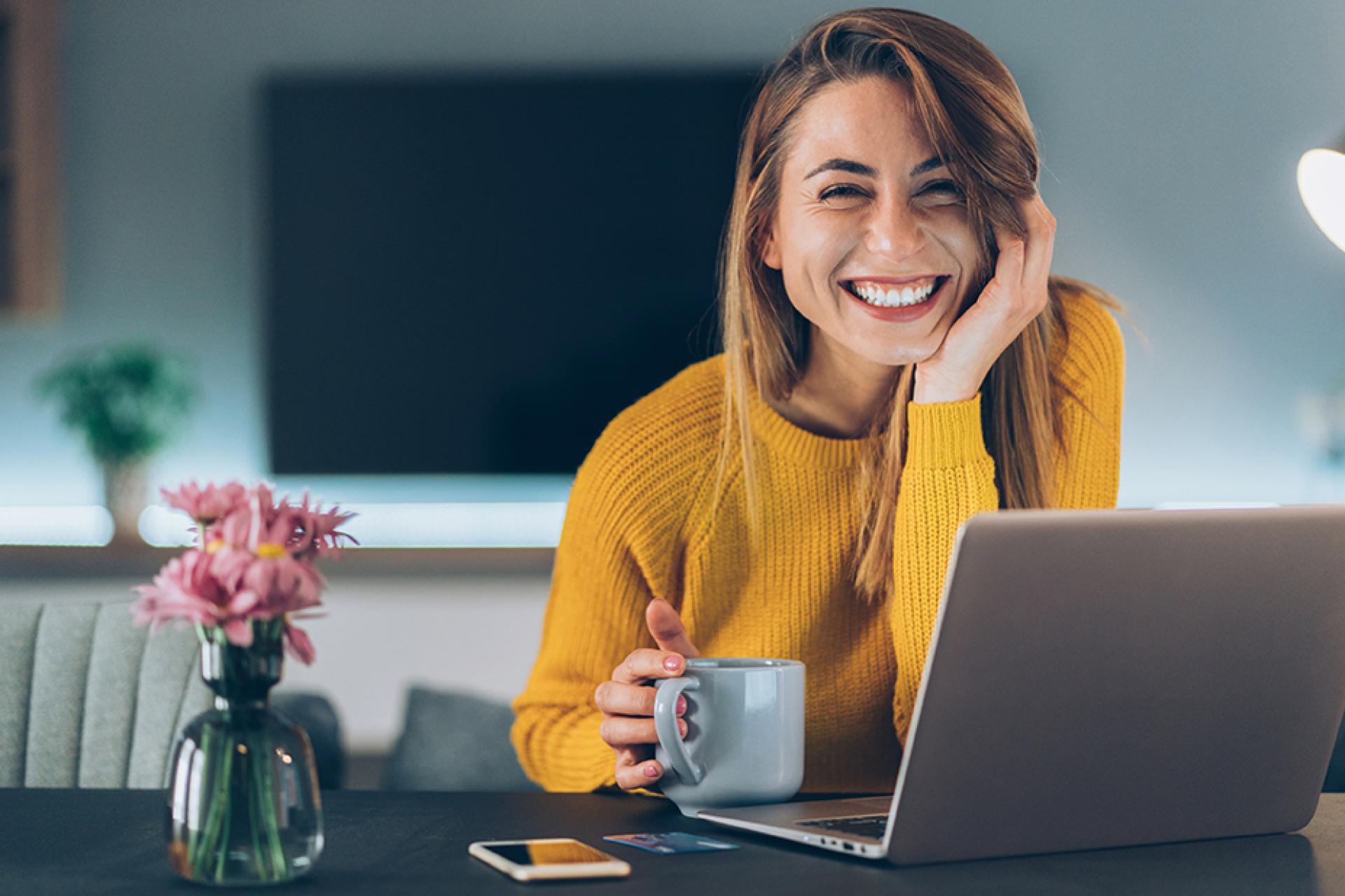 Woman sitting at table with a laptop