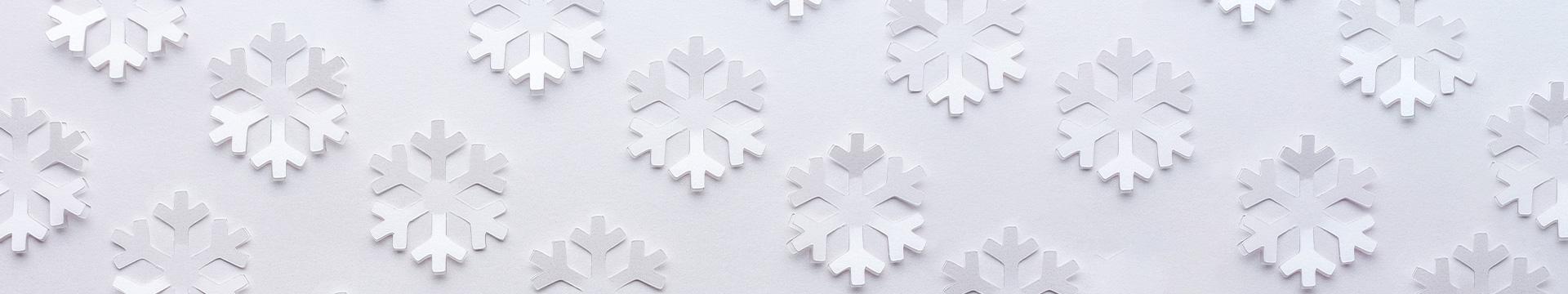 A photo of snowflakes made out of paper. 