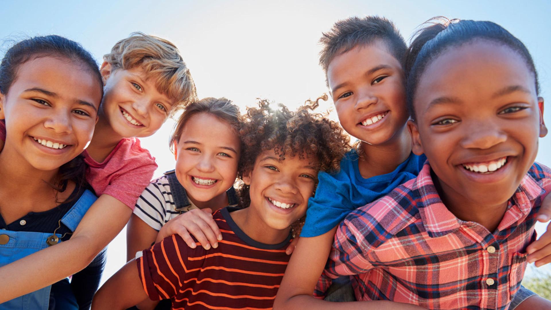 A group of kids looking at the camera. 