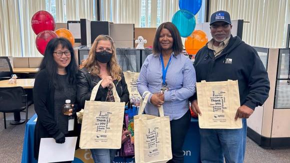 Our Hope Street Branch staff and members receiving their grocery tote