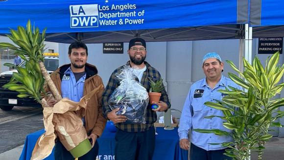 LADWP employees posing with their raffle prizes.