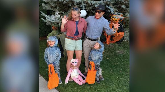 A family dressed up in costumes. 
