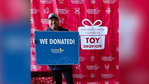 A person holding up a sign that states "We Donated" 