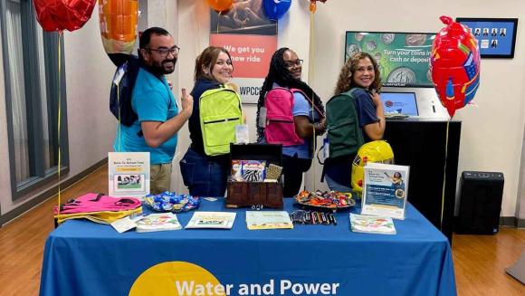 WPCCU staff with backpacks posing for a photo