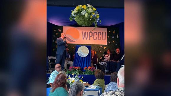 Audience listening to presenters on stage