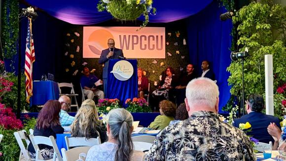 Audience listening to presenters on stage