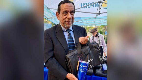 Former CEO, Carl E. Stewart, presenting giveaway items. 