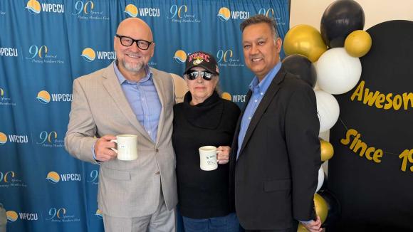 WPCCU staff posing for a photo with a member