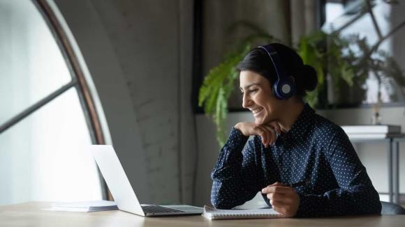 Person attending a meeting on their laptop