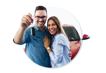 A couple holding the key to their new car