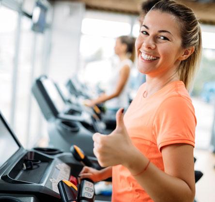A woman is exercising on a treadmill.