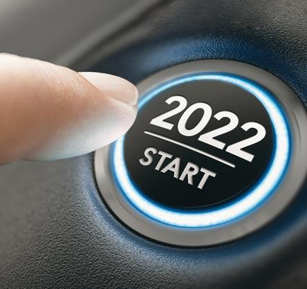 A finger pushing an auto start button that says "2022".