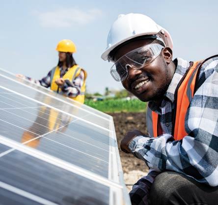 Two workers checking a solar panel 