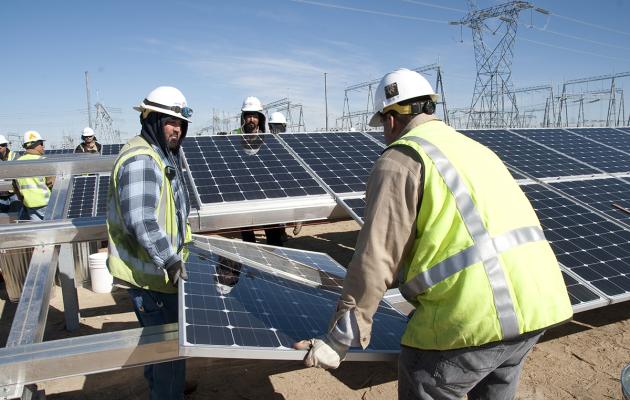 Water and Power workers with solar panels