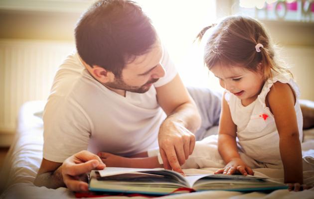Father and daughter reading a book