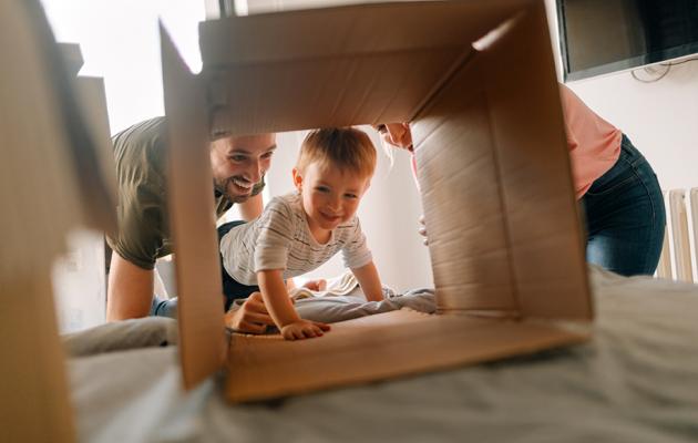 Toddler crawling through moving box