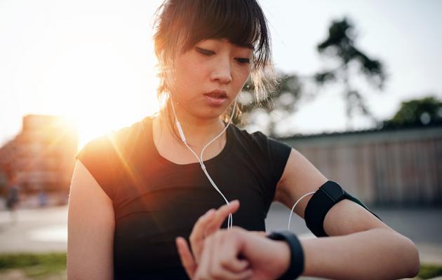 Runner checking her watch for heart rate