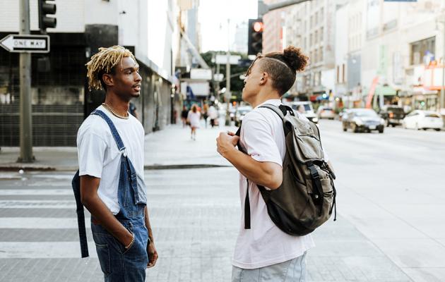 Two men talking on street