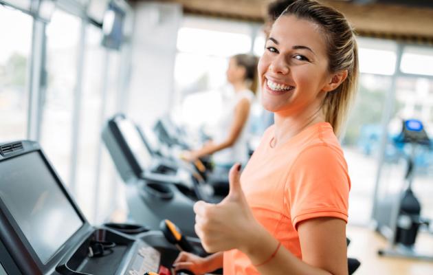 A happy woman on a treadmill. 