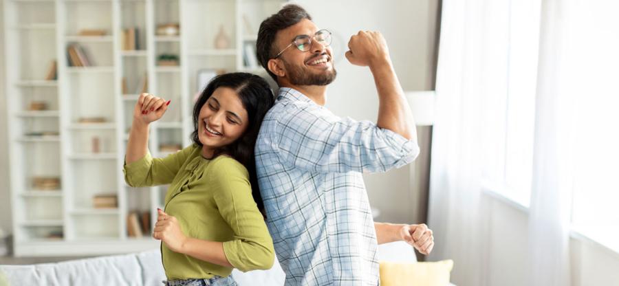 Two people dancing in their living room.
