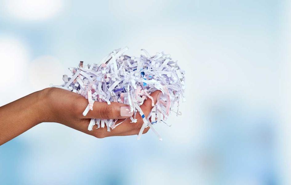 Hand holding shredded paper