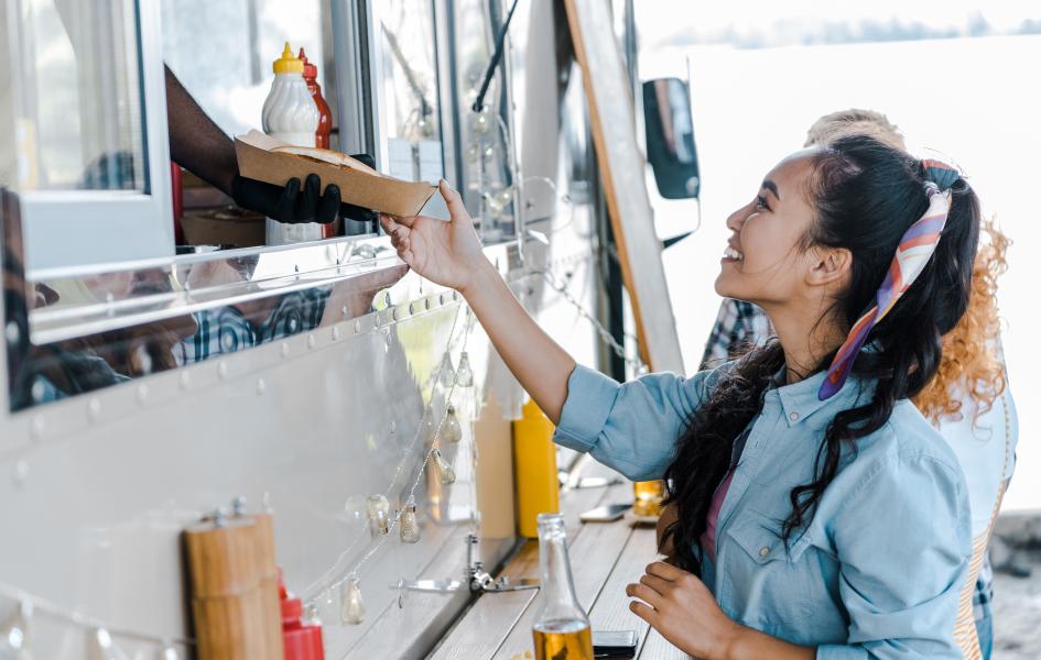 Member receiving order from food truck