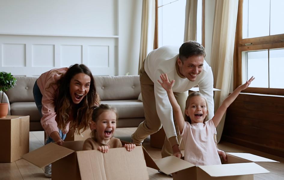 A photo of a family playing with boxes on moving day