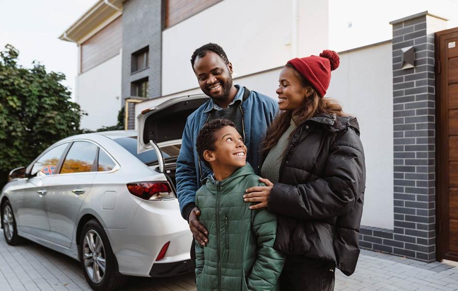 Family in front of new car.