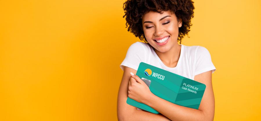 A young lady hugging WPCCU Mastercard
