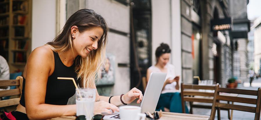 Woman sitting at a table looking at computer