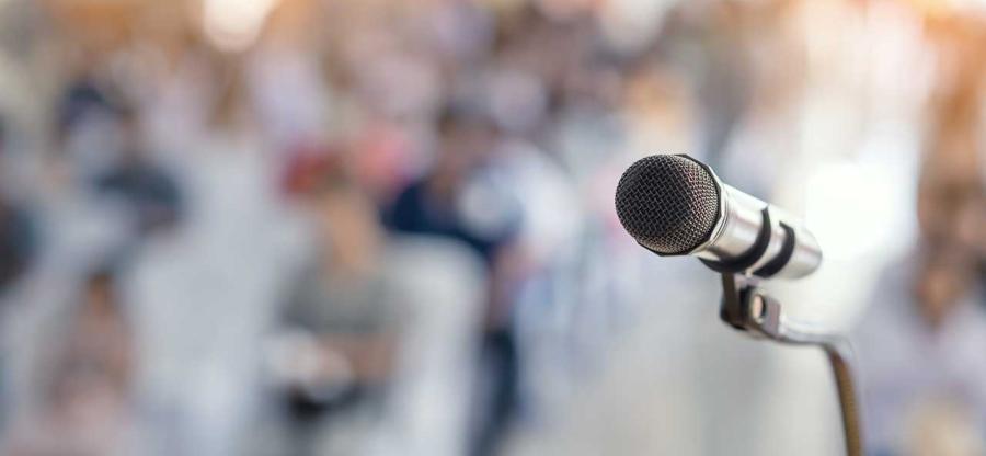 A microphone in front of an audience.