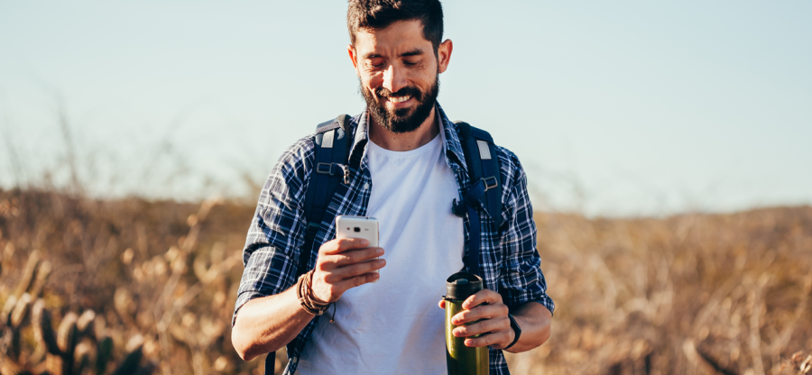 A hiker holding a smartphone