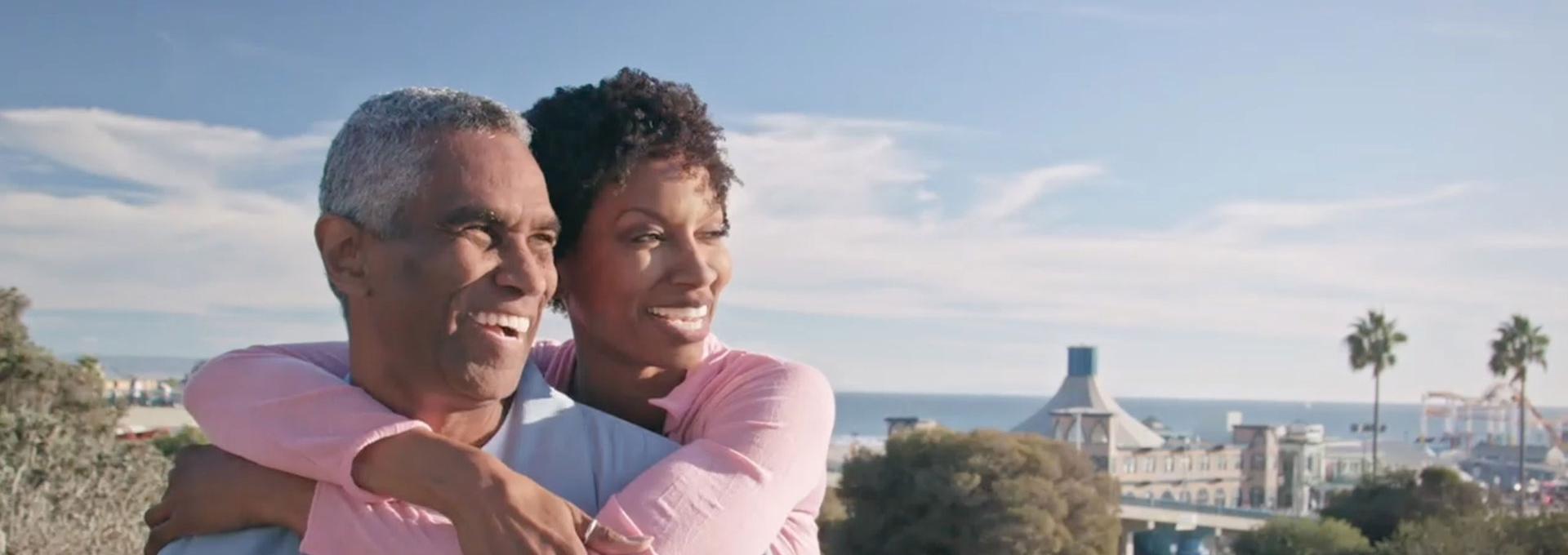 happy, retired couple looking out over the city