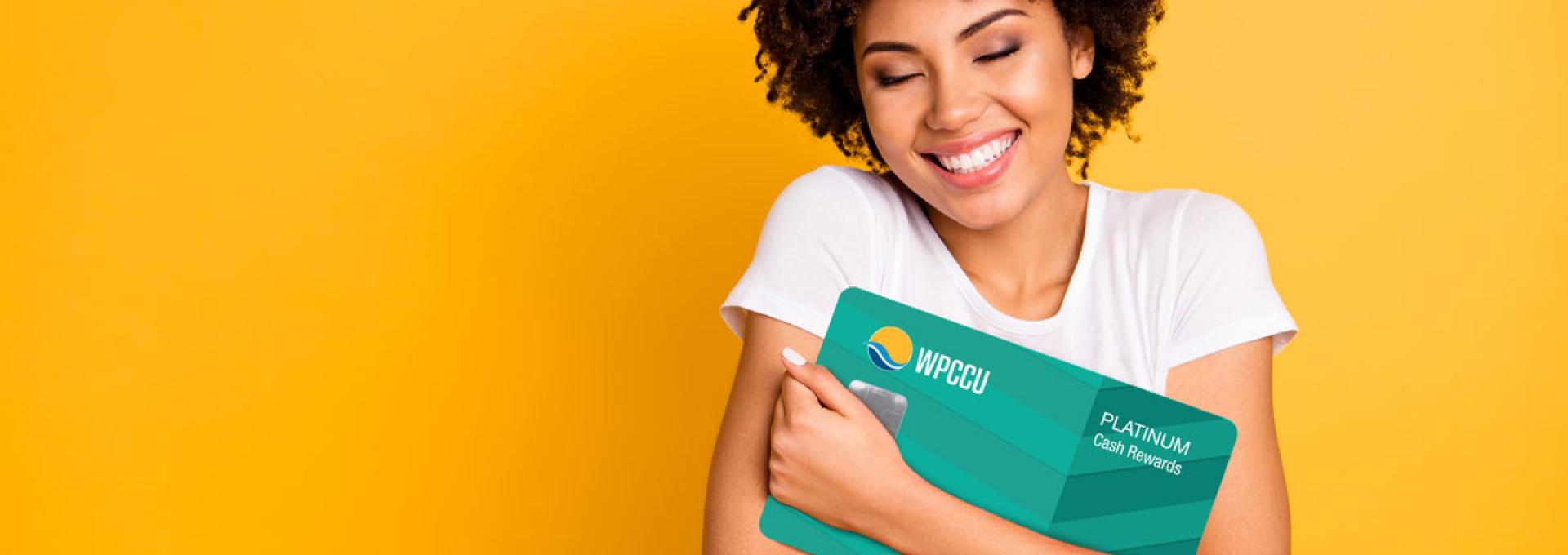 A young lady hugging WPCCU Mastercard