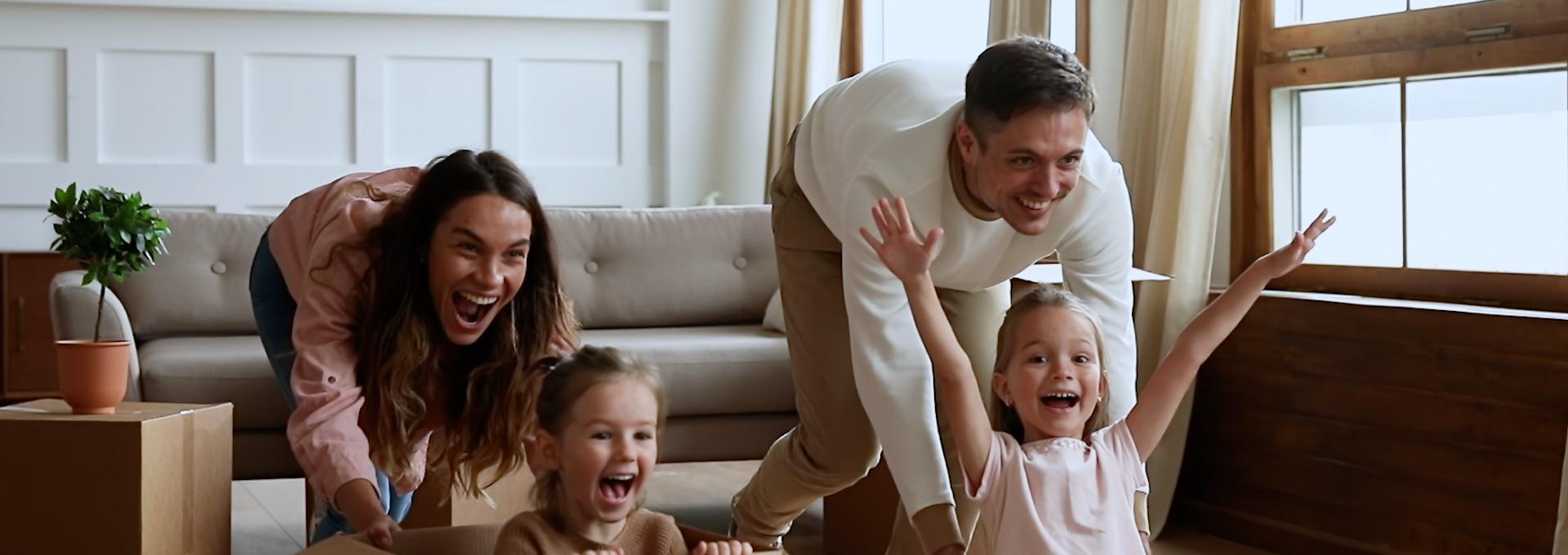 A photo of a family playing with boxes on moving day