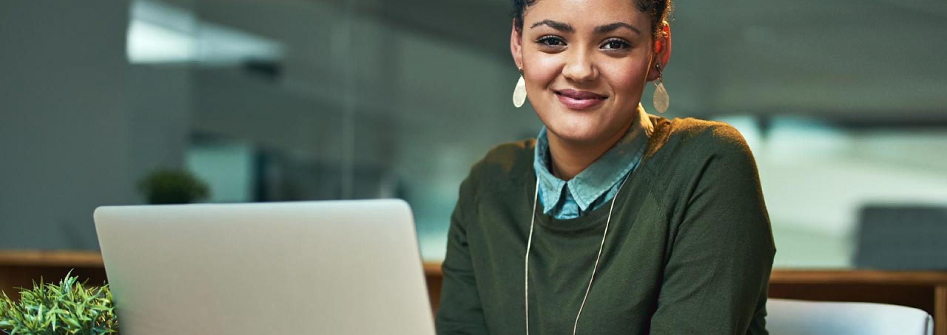 Portrait of a woman working on her laptop.