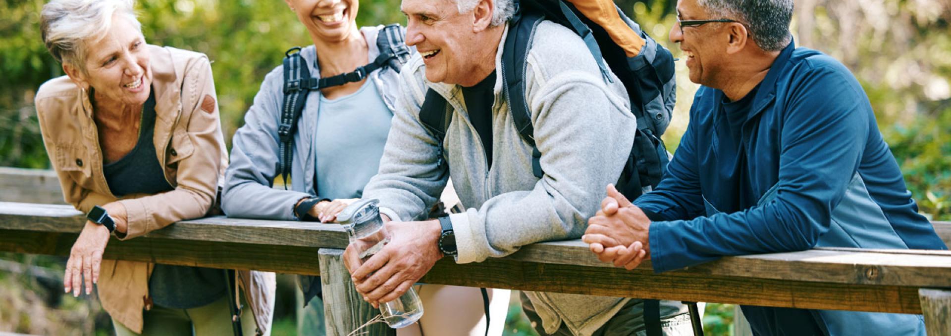 People standing over a bridge talking