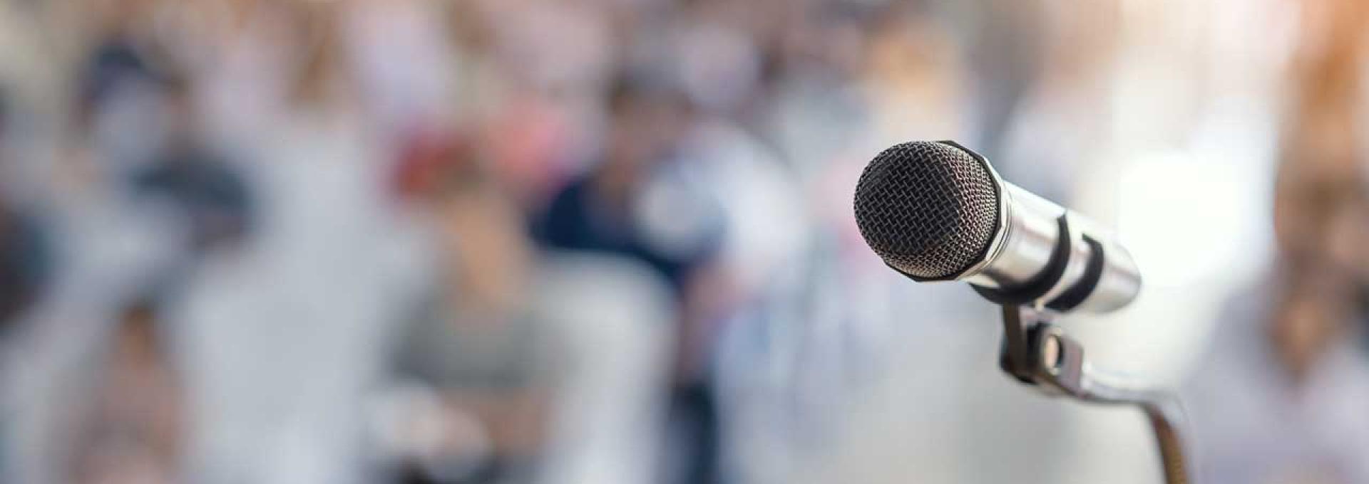 A microphone in front of an audience. 