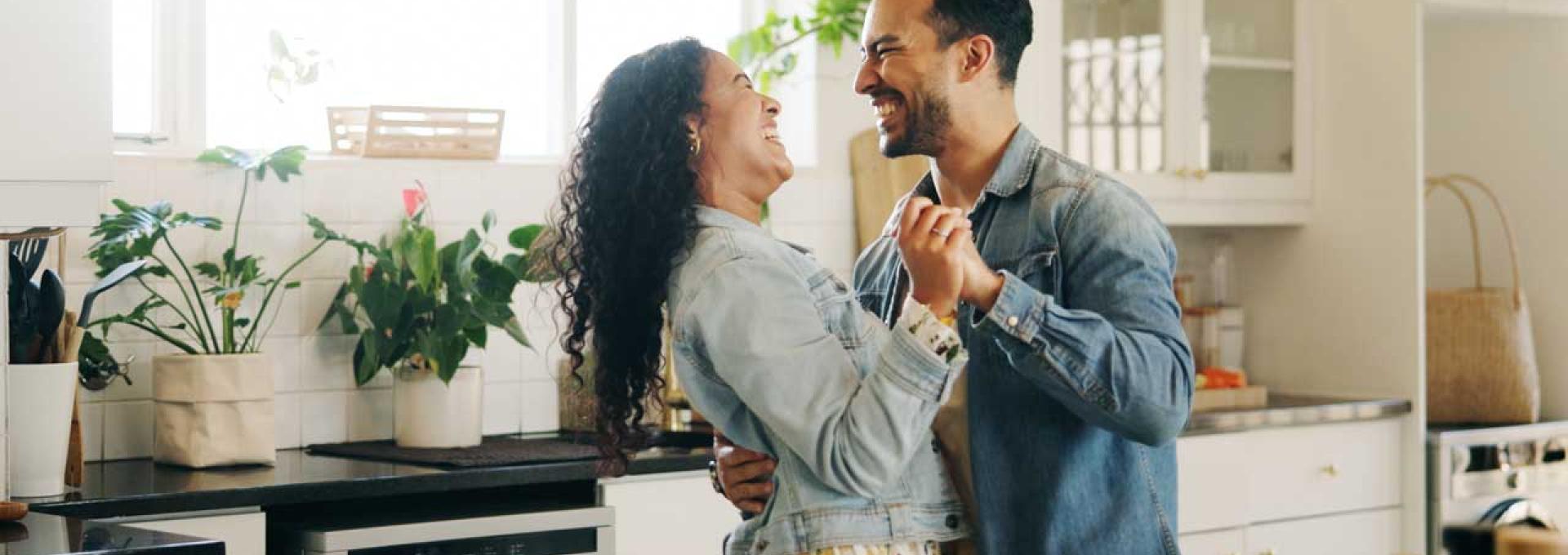 Two people dancing in a kitchen