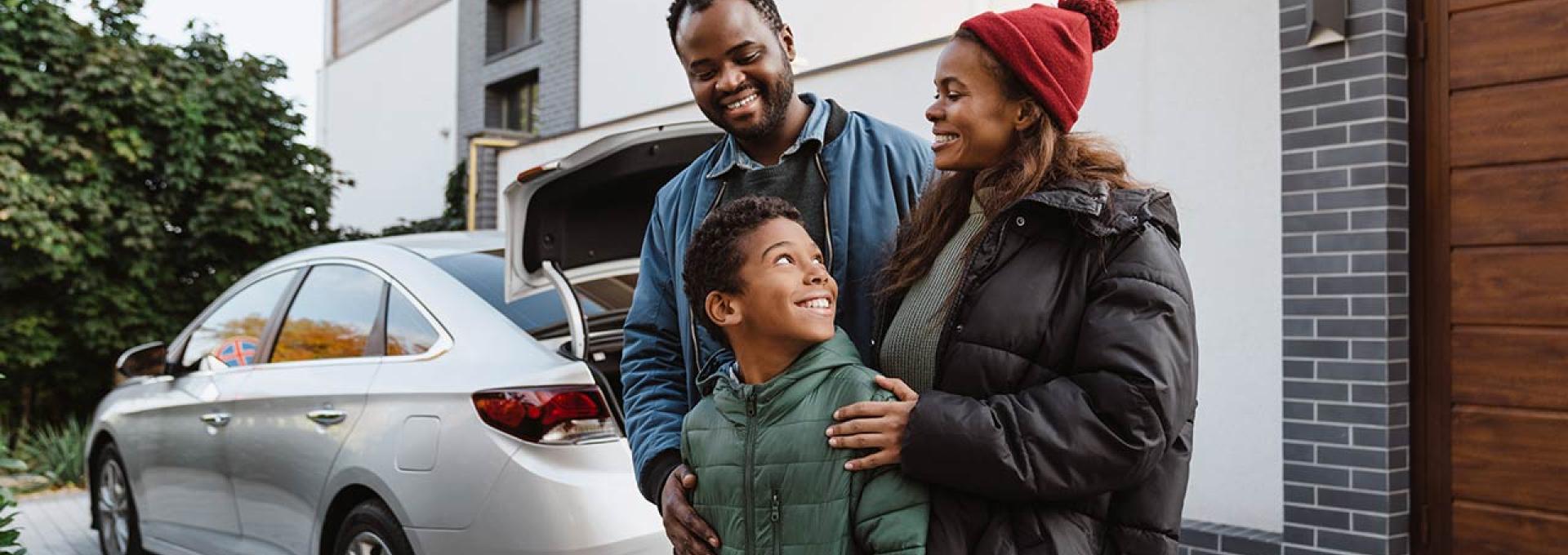 Family in front of new car.
